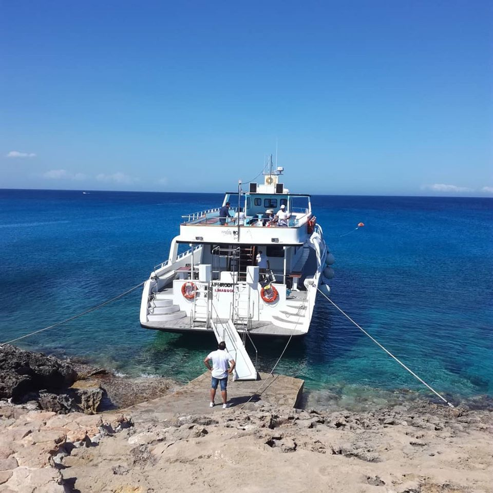 Aphrodite II passing by coastal scenery